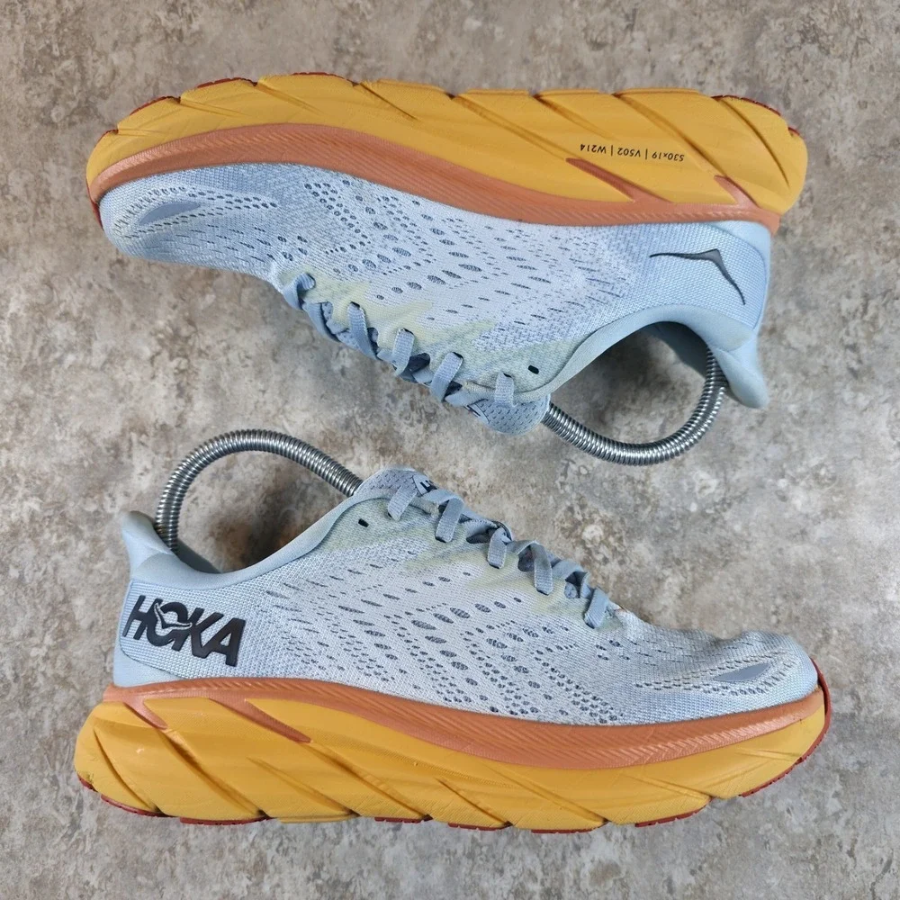 Hoka One One Women's Light Blue Running Shoes with Yellow and Orange Midsole